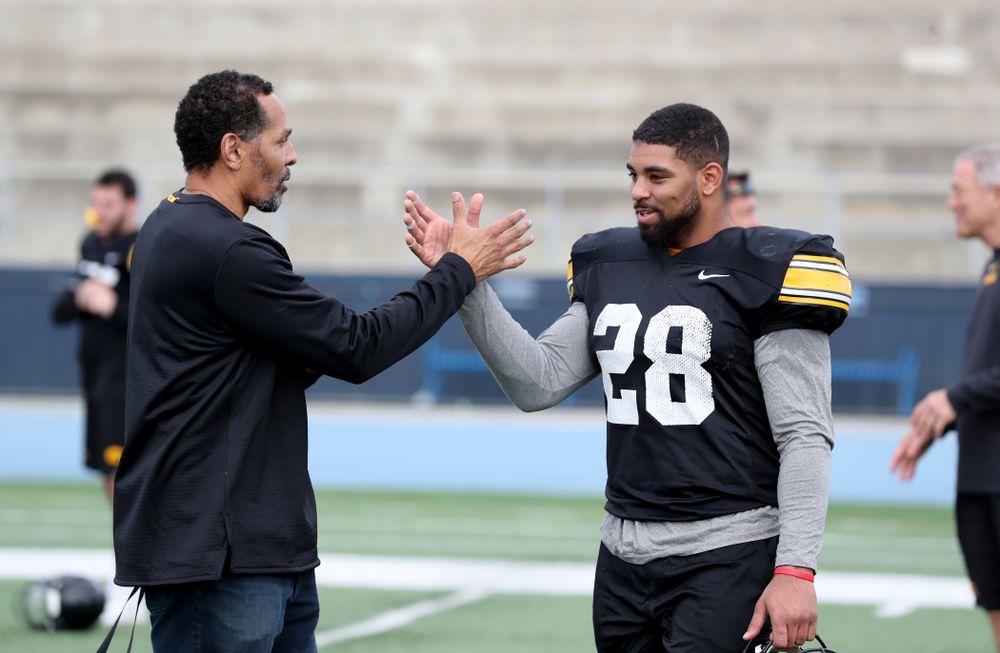 Former Hawkeye Football player Quinn Early talks with running back Toren Young (28) following Holiday Bowl Practice No. 3  Tuesday, December 24, 2019 at San Diego Mesa College. (Brian Ray/hawkeyesports.com)