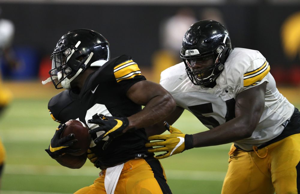 Iowa Hawkeyes running back Mekhi Sargent (10) and defensive tackle Daviyon Nixon (54) during Fall Camp Practice No. 6 Thursday, August 8, 2019 at the Ronald D. and Margaret L. Kenyon Football Practice Facility. (Brian Ray/hawkeyesports.com)