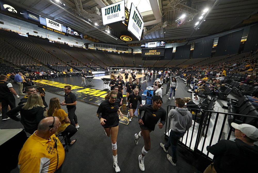 The Iowa Hawkeyes run off the court after warming up before their match at Carver-Hawkeye Arena in Iowa City on Sunday, Oct 20, 2019. (Stephen Mally/hawkeyesports.com)