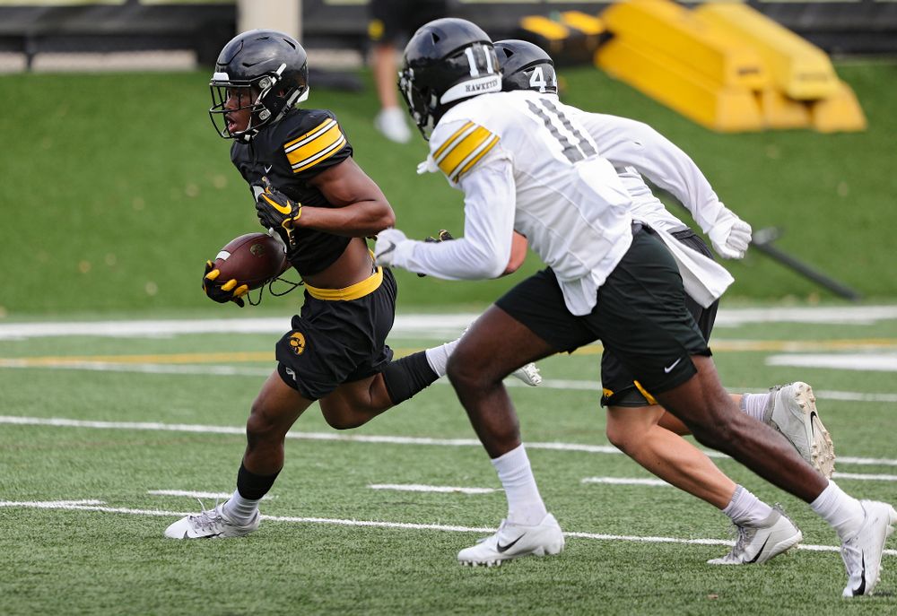 Iowa Hawkeyes wide receiver Tyrone Tracy Jr. (3) tries to get around defensive back Michael Ojemudia (11) and linebacker Seth Benson (44) after pulling in a pass during Fall Camp Practice No. 15 at the Hansen Football Performance Center in Iowa City on Monday, Aug 19, 2019. (Stephen Mally/hawkeyesports.com)