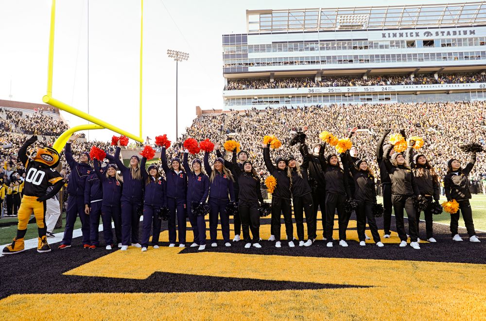 Iowa Spirit Squad members and Illinois Fighting Illini cheerleaders wave to the University of Iowa Stead Family Children's Hospital between the first and second quarter of their game at Kinnick Stadium in Iowa City on Saturday, Nov 23, 2019. (Stephen Mally/hawkeyesports.com)