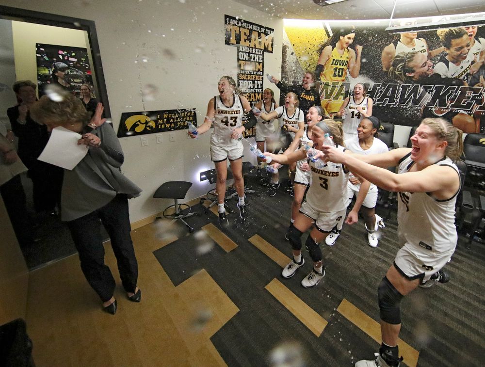 The Hawkeyes sprays head coach Lisa Bluder with water as she enters the locker room after their double overtime win at Carver-Hawkeye Arena in Iowa City on Sunday, January 12, 2020. (Stephen Mally/hawkeyesports.com)