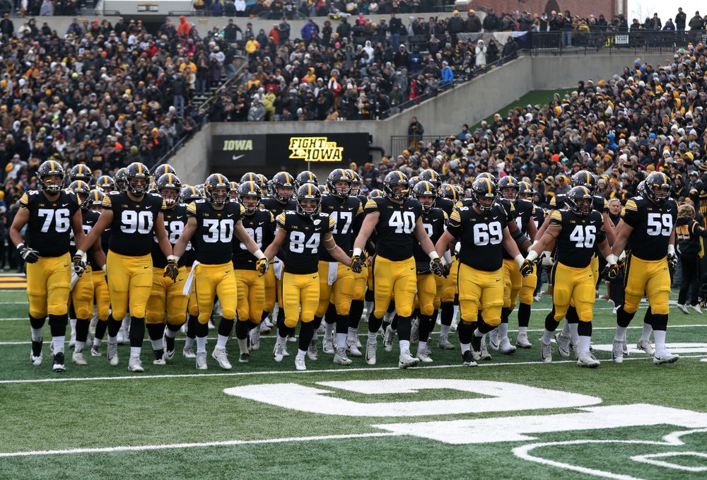 The Iowa Hawkeyes swarm onto the field for their game against the Northwestern Wildcats Saturday, November 10, 2018 at Kinnick Stadium. (Brian Ray/hawkeyesports.com)
