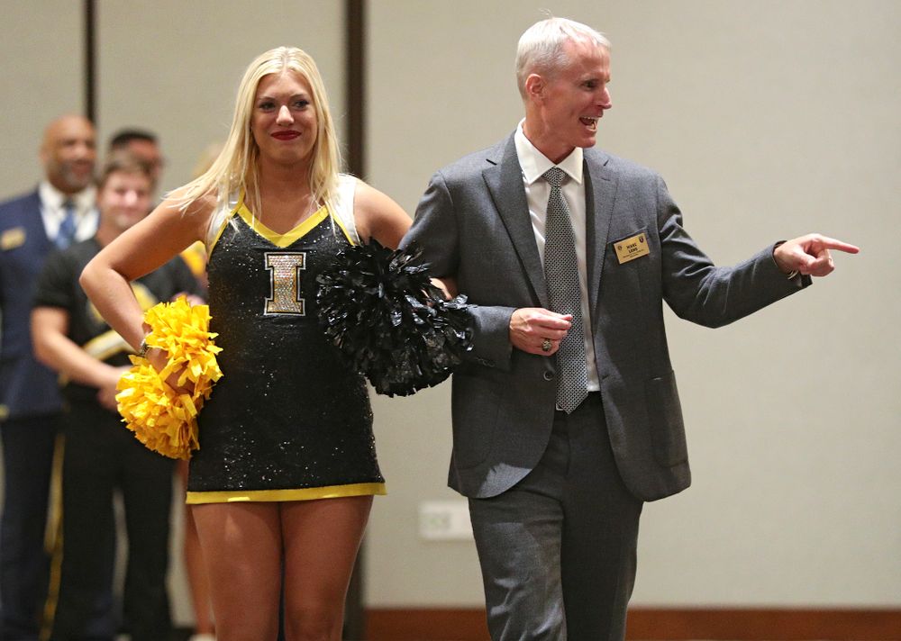 2019 University of Iowa Athletics Hall of Fame inductee Marc Long walks to his seat with a Spirit Squad member during the Hall of Fame Induction Ceremony at the Coralville Marriott Hotel and Conference Center in Coralville on Friday, Aug 30, 2019. (Stephen Mally/hawkeyesports.com)