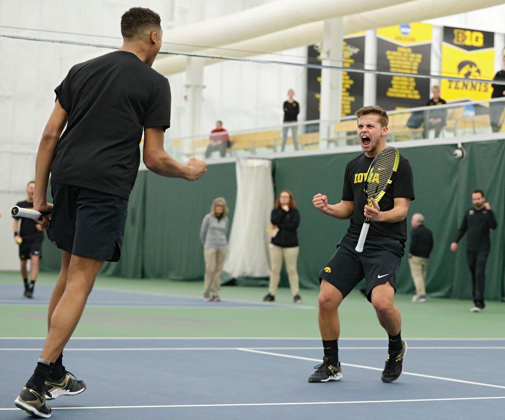 Iowa’s Oliver Okonkwo (from left) and Will Davies celebrate a point during their doubles match at the Hawkeye Tennis and Recreation Complex in Iowa City on Friday, February 14, 2020. (Stephen Mally/hawkeyesports.com)