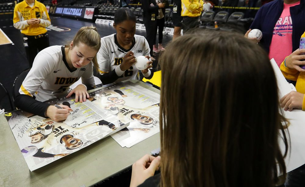 Iowa Hawkeyes outside hitter Meghan Buzzerio (5) and Iowa Hawkeyes outside hitter Taylor Louis (16) sign autographs for fans after a match against Rutgers at Carver-Hawkeye Arena on November 2, 2018. (Tork Mason/hawkeyesports.com)