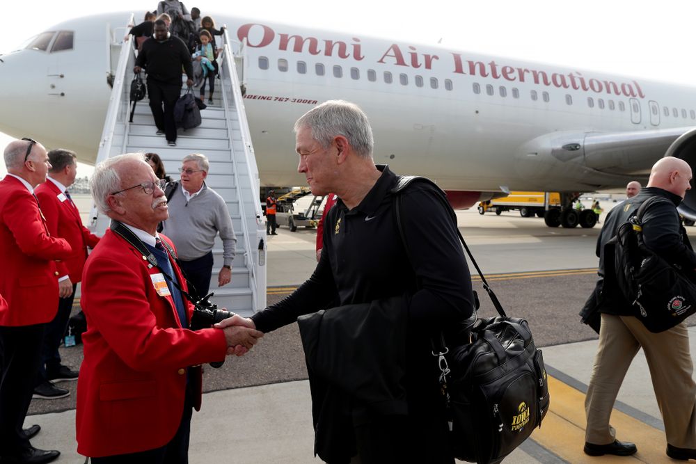Iowa Hawkeyes head coach Kirk Ferentz shakes hands with the ÒRed CoatsÓ after arriving in San Diego, CA Saturday, December 21, 2019 for the Holiday Bowl. (Brian Ray/hawkeyesports.com)