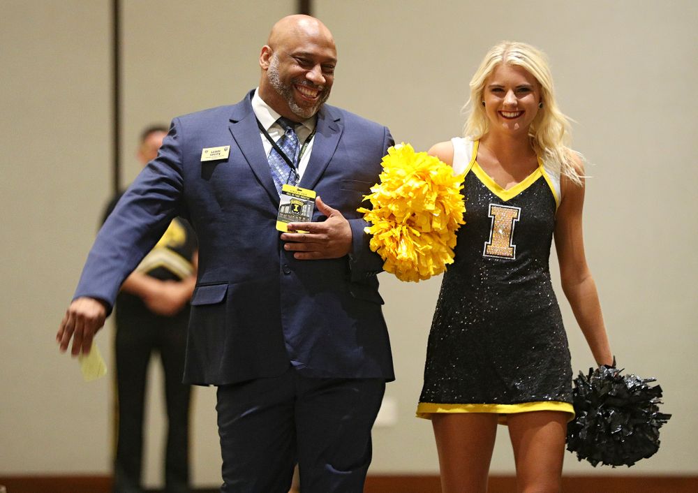 2019 University of Iowa Athletics Hall of Fame inductee LeRoy Smith walks to his seat with a Spirit Squad member during the Hall of Fame Induction Ceremony at the Coralville Marriott Hotel and Conference Center in Coralville on Friday, Aug 30, 2019. (Stephen Mally/hawkeyesports.com)
