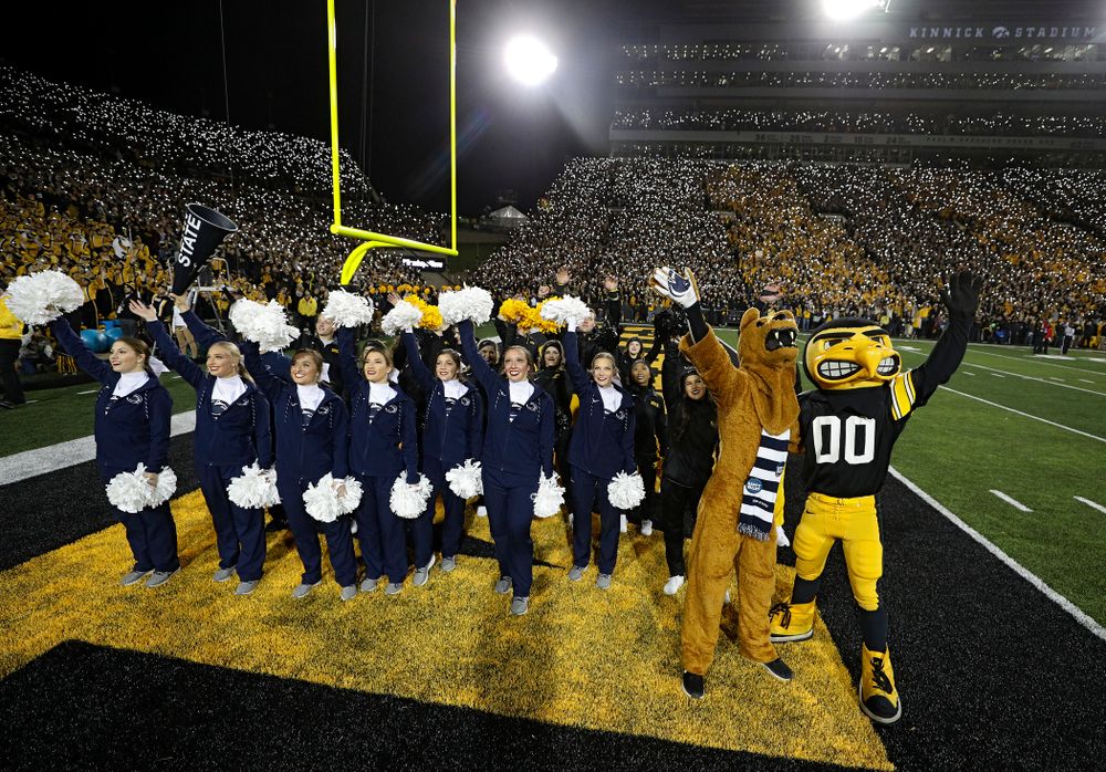 The Penn State cheerleaders and the Nittany Lion stand with the Iowa Hawkeyes cheerleaders and Herky as they wave to the University of Iowa Stead Family Children's Hospital between the first and second quarters of their game at Kinnick Stadium in Iowa City on Saturday, Oct 12, 2019. (Stephen Mally/hawkeyesports.com)