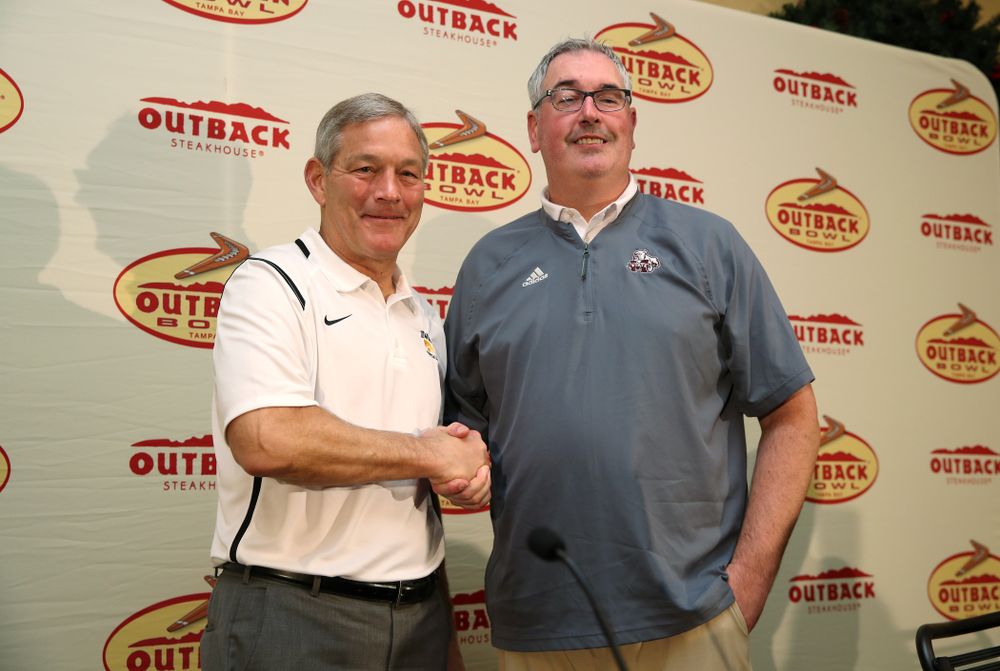 Iowa Hawkeyes head coach Kirk Ferentz and Mississippi State head coach Joe Moorhead shake hands during the Outback Bowl coach's press conference Saturday, December 29, 2018 in Tampa, FL. (Brian Ray/hawkeyesports.com)