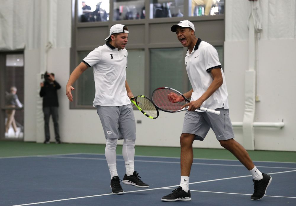 Iowa's Will Davies and Oliver Okonkwo celebrate after winning a doubles match against Western Michigan Saturday, January 19, 2019 at the Hawkeye Tennis and Recreation Complex. (Brian Ray/hawkeyesports.com)