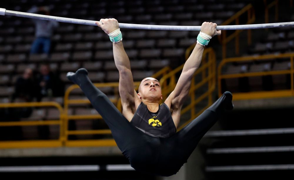 Iowa's Andrew Herrador competes on the high bar 