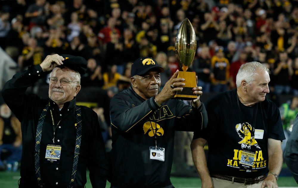 Willie Flemming hols up the  19058 National Championship  trophy as the team is introduced during  the Iowa Hawkeyes game against the Wisconsin Badgers Saturday, September 22, 2018 at Kinnick Stadium. (Brian Ray/hawkeyesports.com)