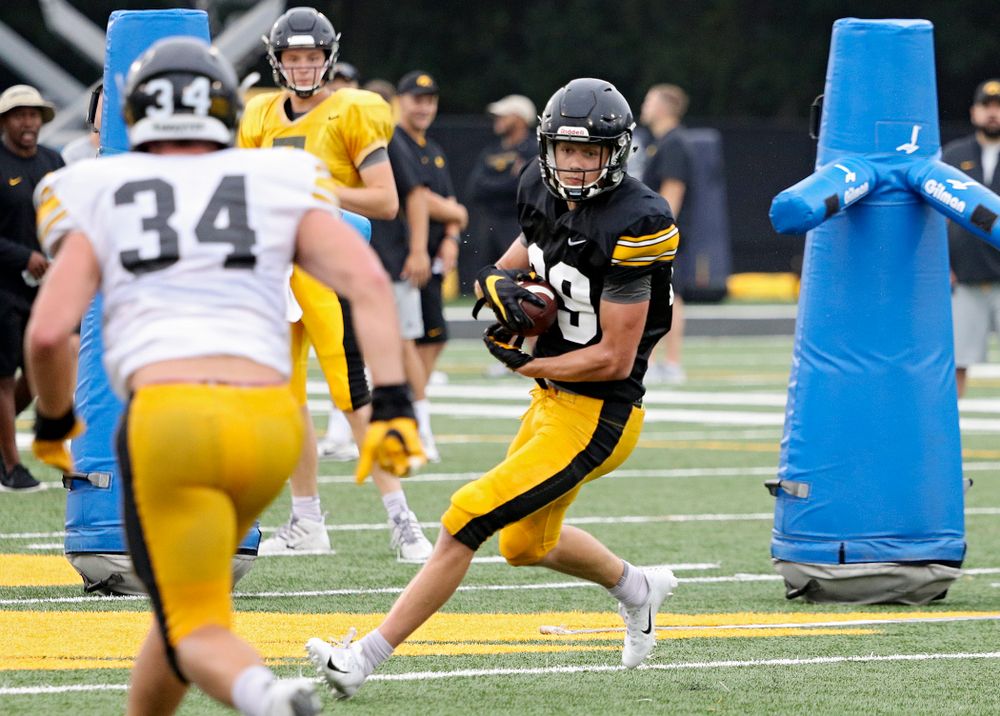 Iowa Hawkeyes wide receiver Jackson Ritter (29) pulls in a pass as linebacker Kristian Welch (34) closes in durning Fall Camp Practice No. 17 at the Hansen Football Performance Center in Iowa City on Wednesday, Aug 21, 2019. (Stephen Mally/hawkeyesports.com)