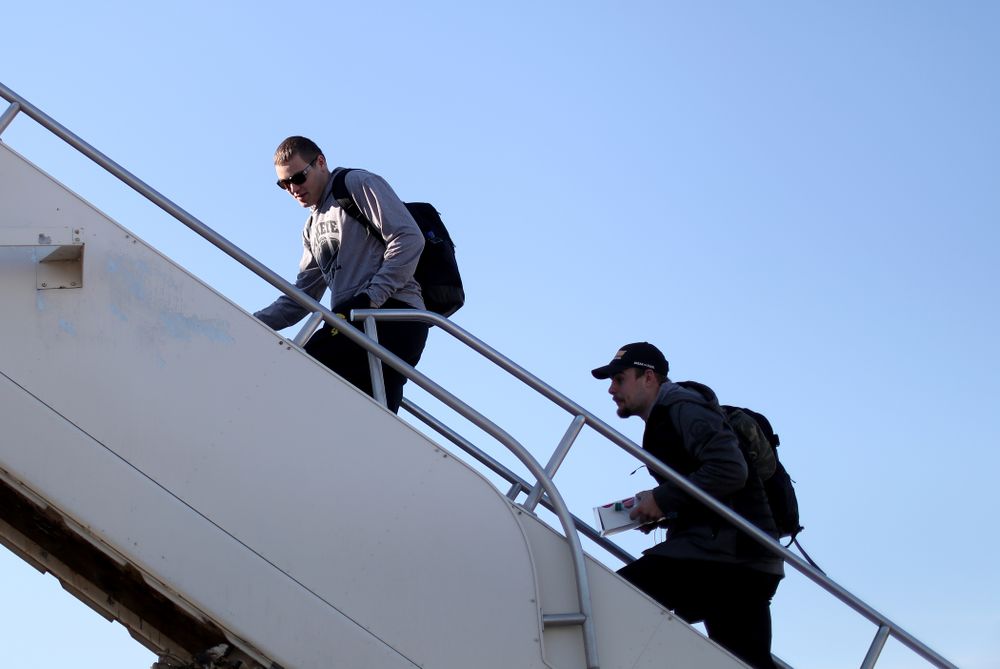 Iowa Hawkeyes quarterback Nate Stanley (4) and quarterback Peyton Mansell (2) board the team plane at the Eastern Iowa Airport Saturday, December 21, 2019 on the way to San Diego, CA for the Holiday Bowl. (Brian Ray/hawkeyesports.com)