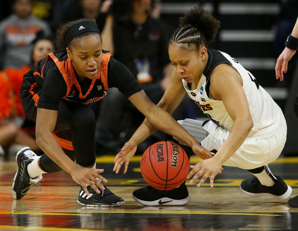Iowa Hawkeyes guard Tania Davis (11) and Mercer Bears guard Keke Calloway (left) battle for a loose ball during the first round of the 2019 NCAA Women's Basketball Tournament at Carver Hawkeye Arena in Iowa City on Friday, Mar. 22, 2019. (Stephen Mally for hawkeyesports.com)
