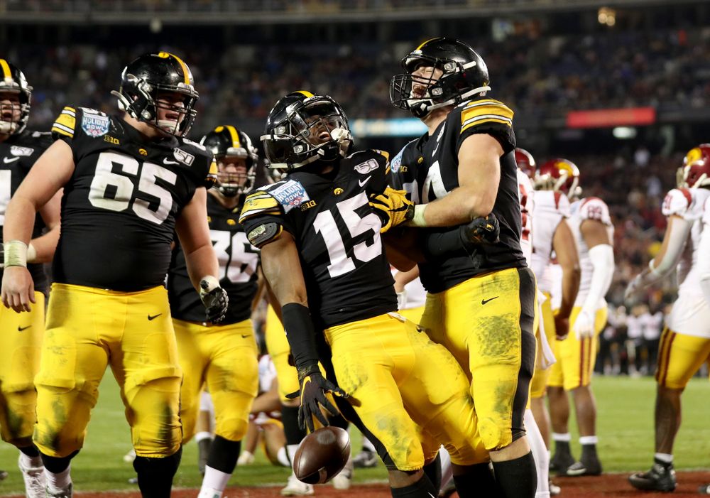 Iowa Hawkeyes running back Tyler Goodson (15) celebrates with tight end Sam LaPorta (84) after scoring against USC in the Holiday Bowl Friday, December 27, 2019 at San Diego Community Credit Union Stadium.  (Brian Ray/hawkeyesports.com)