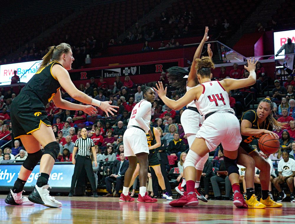 Iowa guard Alexis Sevillian (5) passes the ball to forward/center Monika Czinano (25) during the third quarter of their game at the Rutgers Athletic Center in Piscataway, N.J. on Sunday, March 1, 2020. (Stephen Mally/hawkeyesports.com)