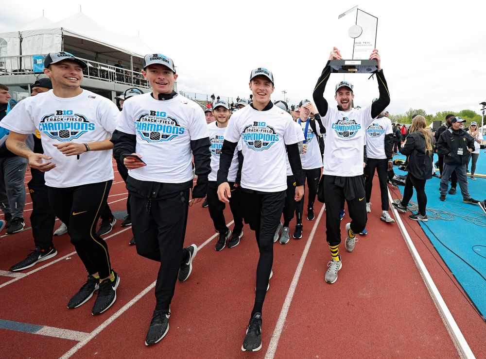 Iowa’s Nolan Teubel holds up their team trophy as he takes a trip around the track with his teammates after winning the Men's Big Ten Outdoor Track and Field Championships on the third day of the Big Ten Outdoor Track and Field Championships at Francis X. Cretzmeyer Track in Iowa City on Sunday, May. 12, 2019. (Stephen Mally/hawkeyesports.com)