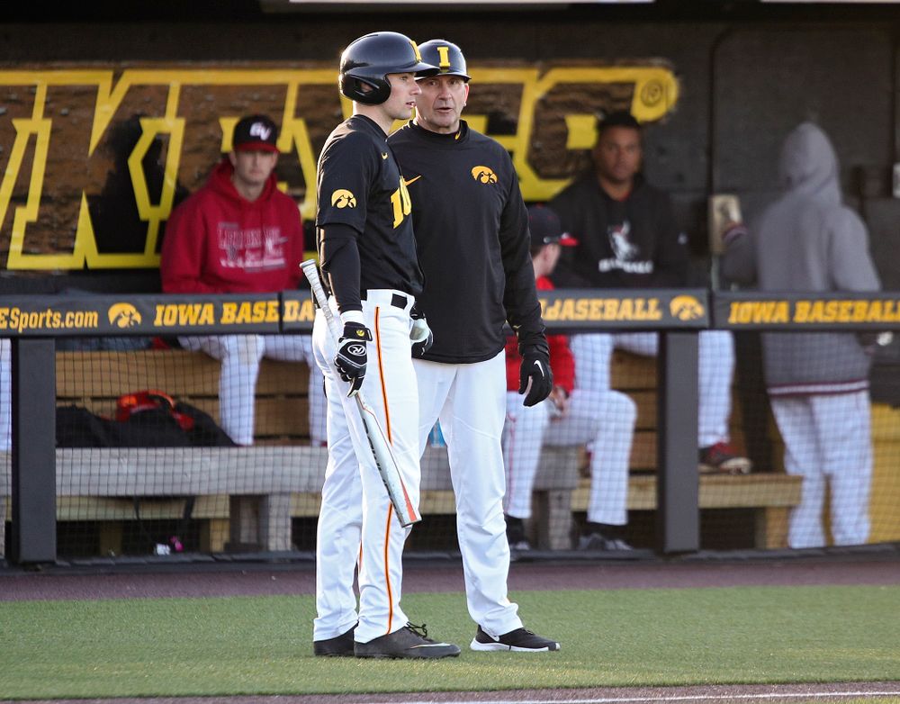 Iowa outfielder Ben Norman (9) talks with head coach Rick Heller before his at bat during the third inning of their game at Duane Banks Field in Iowa City on Tuesday, March 3, 2020. (Stephen Mally/hawkeyesports.com)