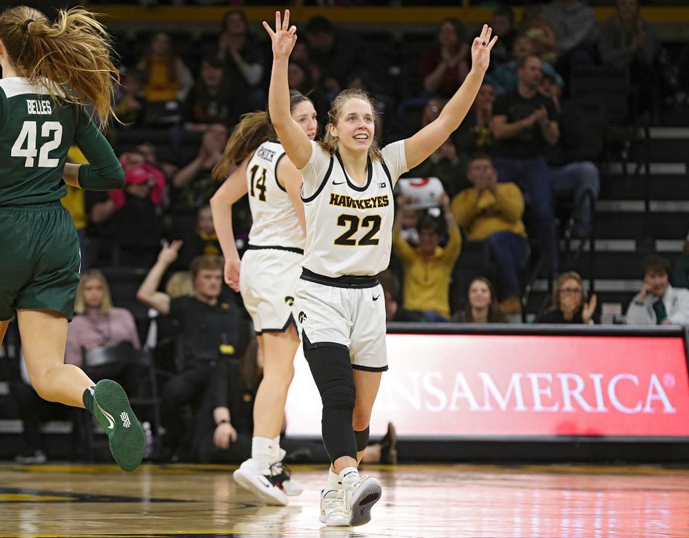 Iowa Hawkeyes guard Kathleen Doyle (22) holds up three fingers in each hand after guard Mckenna Warnock (14) made a 3-pointer during the fourth quarter of their game at Carver-Hawkeye Arena in Iowa City on Sunday, January 26, 2020. (Stephen Mally/hawkeyesports.com)