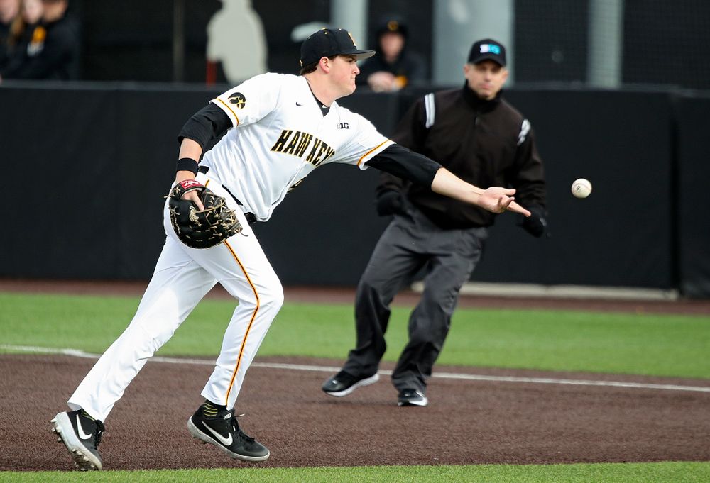 Iowa first baseman Peyton Williams (45) tosses a ball to first for an out during the seventh inning of their college baseball game at Duane Banks Field in Iowa City on Wednesday, March 11, 2020. (Stephen Mally/hawkeyesports.com)