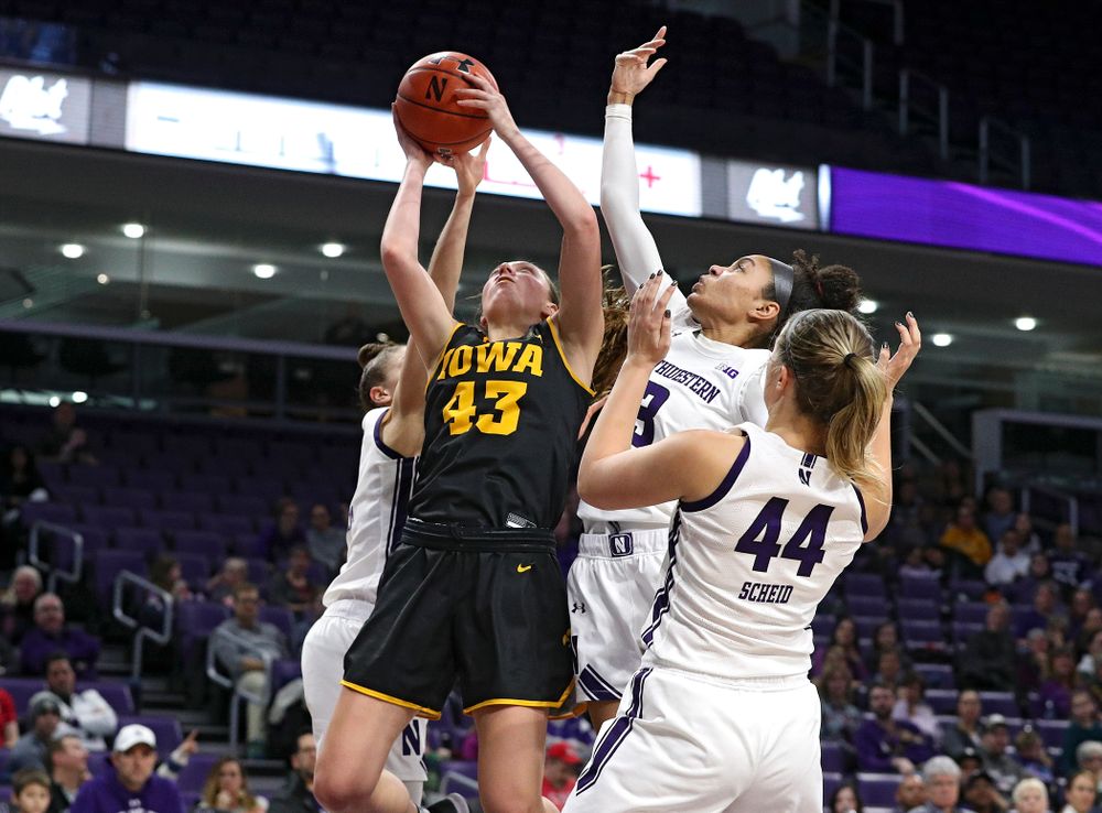 Iowa Hawkeyes forward Amanda Ollinger (43) grabs a rebound during the third quarter of their game at Welsh-Ryan Arena in Evanston, Ill. on Sunday, January 5, 2020. (Stephen Mally/hawkeyesports.com)