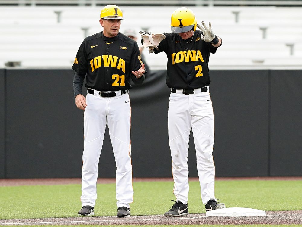 Iowa Hawkeyes second baseman Brendan Sher (2) holds up three fingers as he celebrates next to head coach Rick Heller after hitting a triple during the second inning of their game against Western Illinois at Duane Banks Field in Iowa City on Wednesday, May. 1, 2019. (Stephen Mally/hawkeyesports.com)