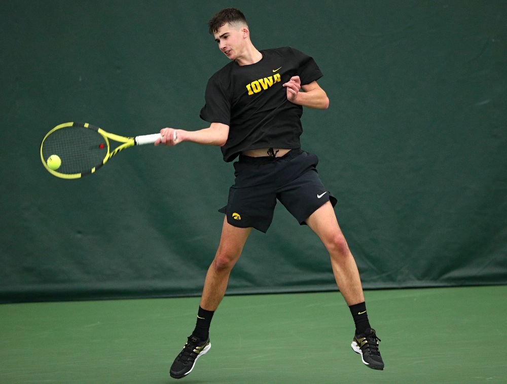 Iowa’s Matt Clegg returns a shot during their match at the Hawkeye Tennis and Recreation Complex in Iowa City on Thursday, January 16, 2020. (Stephen Mally/hawkeyesports.com)