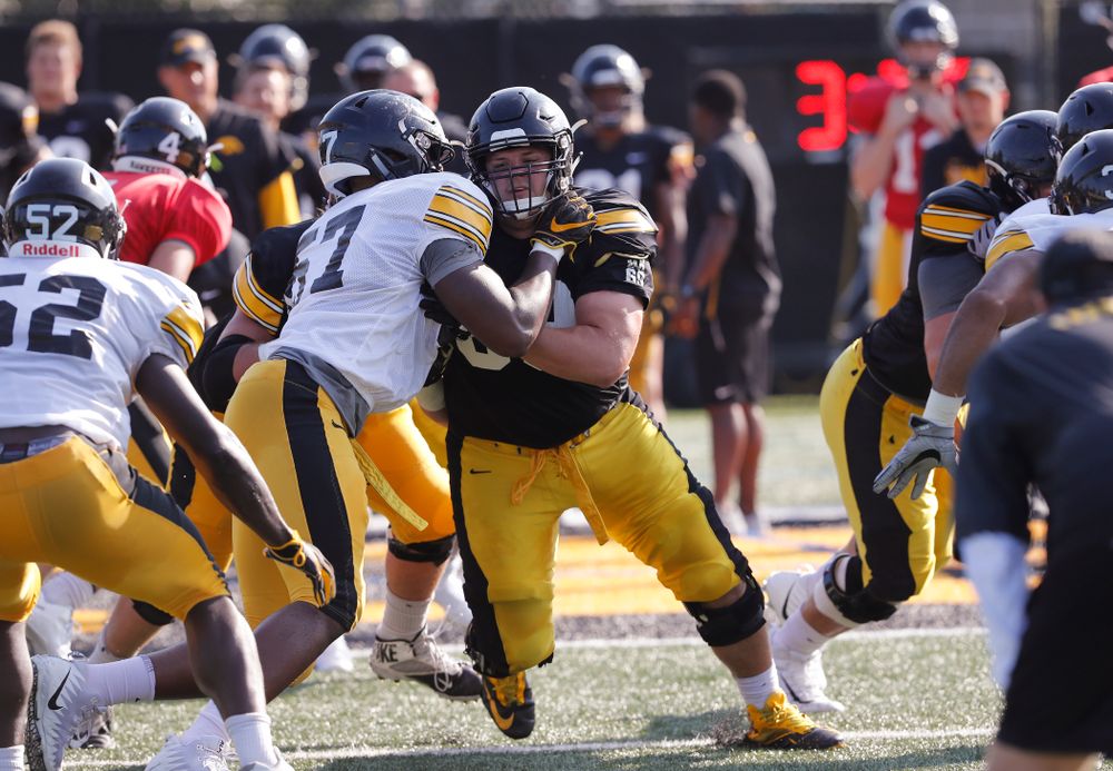 Iowa Hawkeyes offensive lineman Keegan Render (69) and defensive end Chauncey Golston (57) during camp practice No. 17 Wednesday, August 22, 2018 at the Kenyon Football Practice Facility. (Brian Ray/hawkeyesports.com)