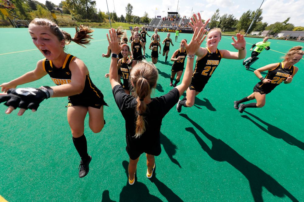 Iowa Hawkeyes Isabella Solaroli (16) and Makenna Maguire (21) high five assistant coach Roz Ellis before their game against the Penn Quakers Friday, September 14, 2018 at Grant Field. (Brian Ray/hawkeyesports.com)