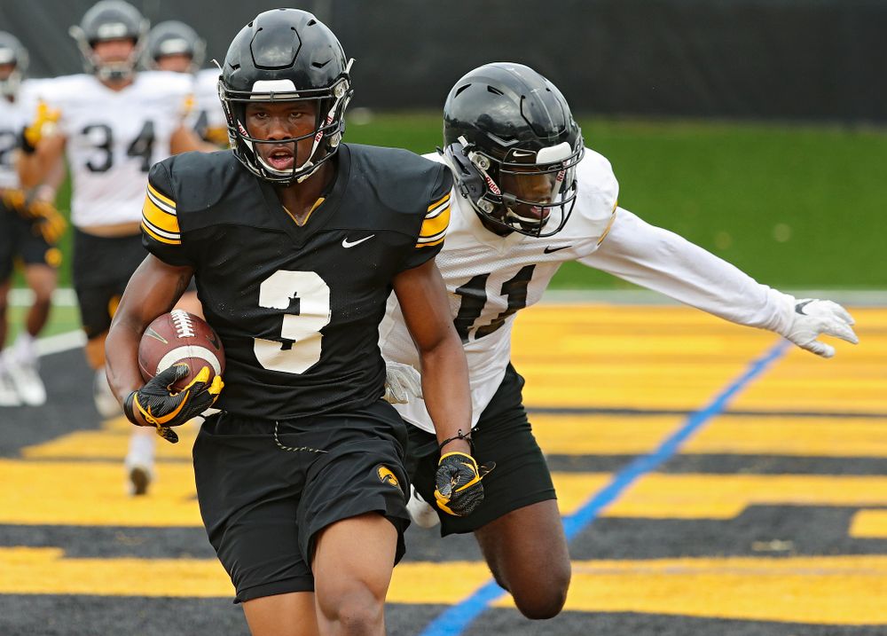 Iowa Hawkeyes wide receiver Tyrone Tracy Jr. (3) pulls in a pass in the end zone around defensive back Michael Ojemudia (11) during Fall Camp Practice No. 15 at the Hansen Football Performance Center in Iowa City on Monday, Aug 19, 2019. (Stephen Mally/hawkeyesports.com)