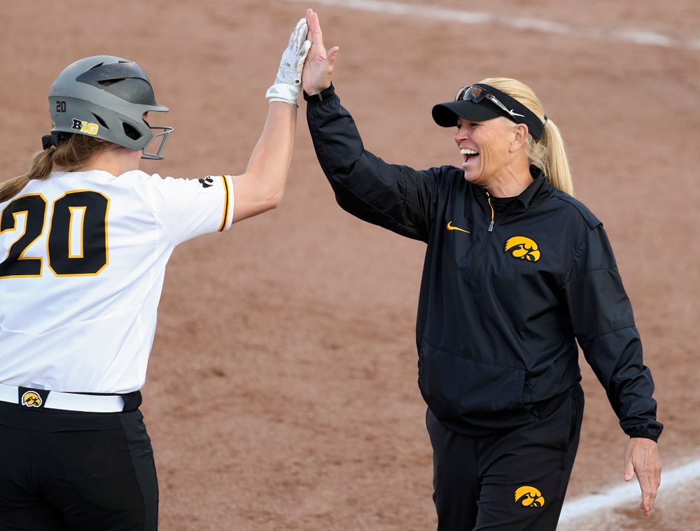 Iowa designated player Miranda Schulte (20) gets a high-five from head coach Renee Gillispie after hitting a home run during the sixth inning of their game against Ohio State at Pearl Field in Iowa City on Friday, May. 3, 2019. (Stephen Mally/hawkeyesports.com)