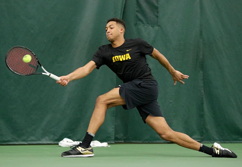 Iowa’s Oliver Okonkwo returns a shot during their match at the Hawkeye Tennis and Recreation Complex in Iowa City on Thursday, January 16, 2020. (Stephen Mally/hawkeyesports.com)