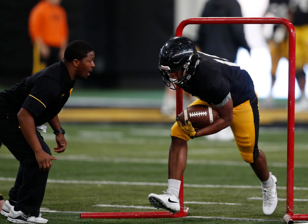 Iowa Hawkeyes running back Kyshaun Bryan (16) and running backs coach Derrick Foster during spring practice Wednesday, March 28, 2018 at the Hansen Football Performance Center.  (Brian Ray/hawkeyesports.com)