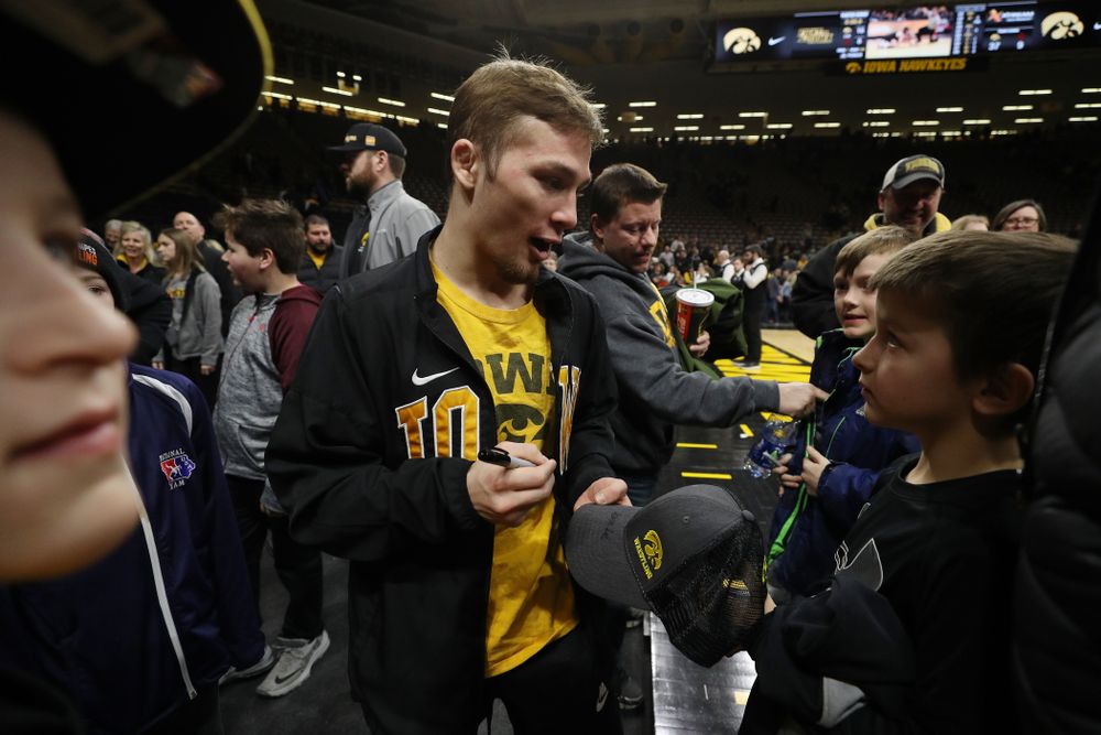 Iowa's Spencer Lee signs autographs following their meet against the Indiana Hoosiers Friday, February 15, 2019 at Carver-Hawkeye Arena. (Brian Ray/hawkeyesports.com)