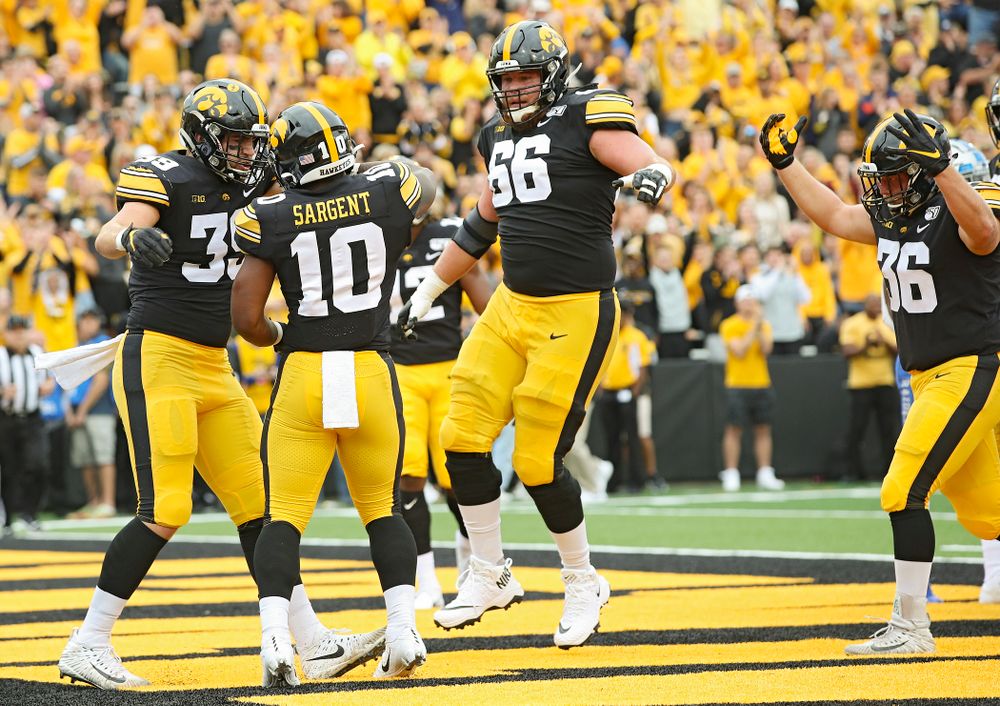 Iowa Hawkeyes running back Mekhi Sargent (10) celebrates his 4-yard touchdown run with tight end Nate Wieting (39) and offensive lineman Levi Paulsen (66) during the first quarter of their game at Kinnick Stadium in Iowa City on Saturday, Sep 28, 2019. (Stephen Mally/hawkeyesports.com)