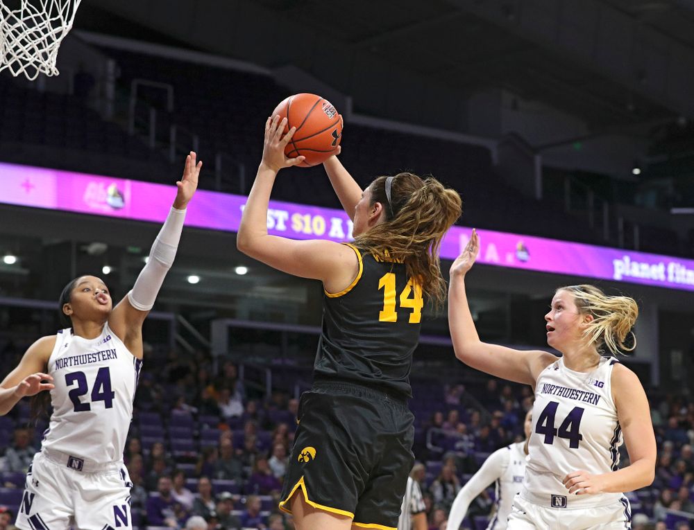 Iowa Hawkeyes guard Mckenna Warnock (14) makes a basket during the fourth quarter of their game at Welsh-Ryan Arena in Evanston, Ill. on Sunday, January 5, 2020. (Stephen Mally/hawkeyesports.com)