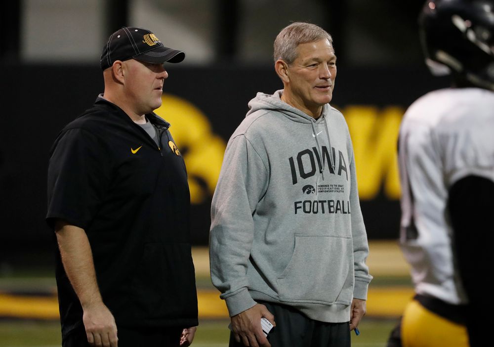 head coach Kirk Ferentz and strength and conditioning coach Chris Doyle