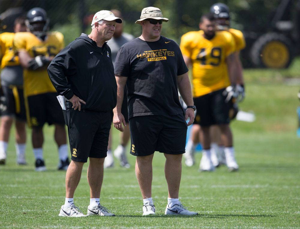 Iowa Hawkeyes Defensive Line coach Reese Morgan and Strength and Conditioning coach Chris Doyle talk during the team's sixth practice of camp Saturday, Aug. 9, 2014 at the Hayden Fry Football Complex in Iowa City.  (Brian Ray/hawkeyesports.com)