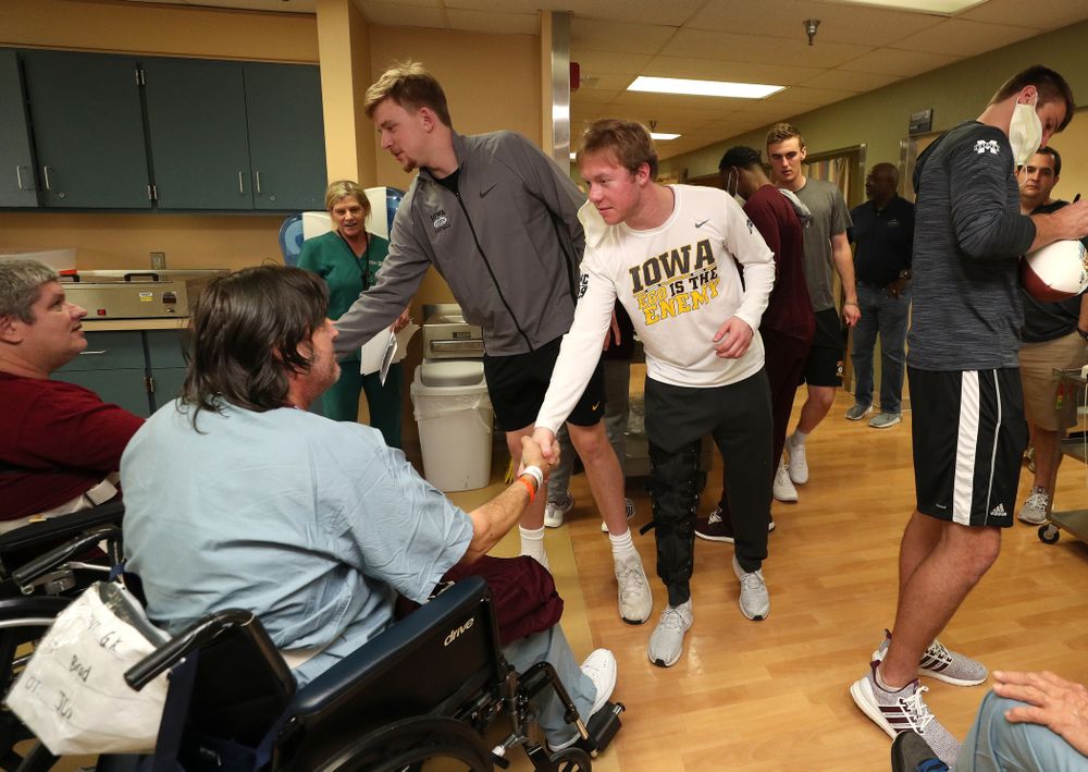 Iowa Hawkeyes quarterback Spencer Petras (7) and wide receiver Max Cooper (19) shake hands with patients during a visit to Tampa General Hospital as part of the Outback Bowl Friday, December 28, 2018 in Tampa, FL.(Brian Ray/hawkeyesports.com)