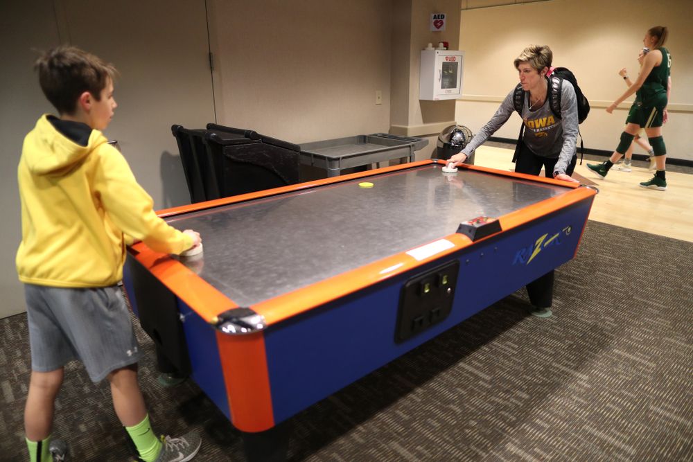 Associate head coach Jan Jensen plays air hockey with her son Jack following shoot around before their regional final against the Baylor Lady Bears in the 2019 NCAA Women's College Basketball Tournament Monday, April 1, 2019 at Greensboro Coliseum in Greensboro, NC.(Brian Ray/hawkeyesports.com)