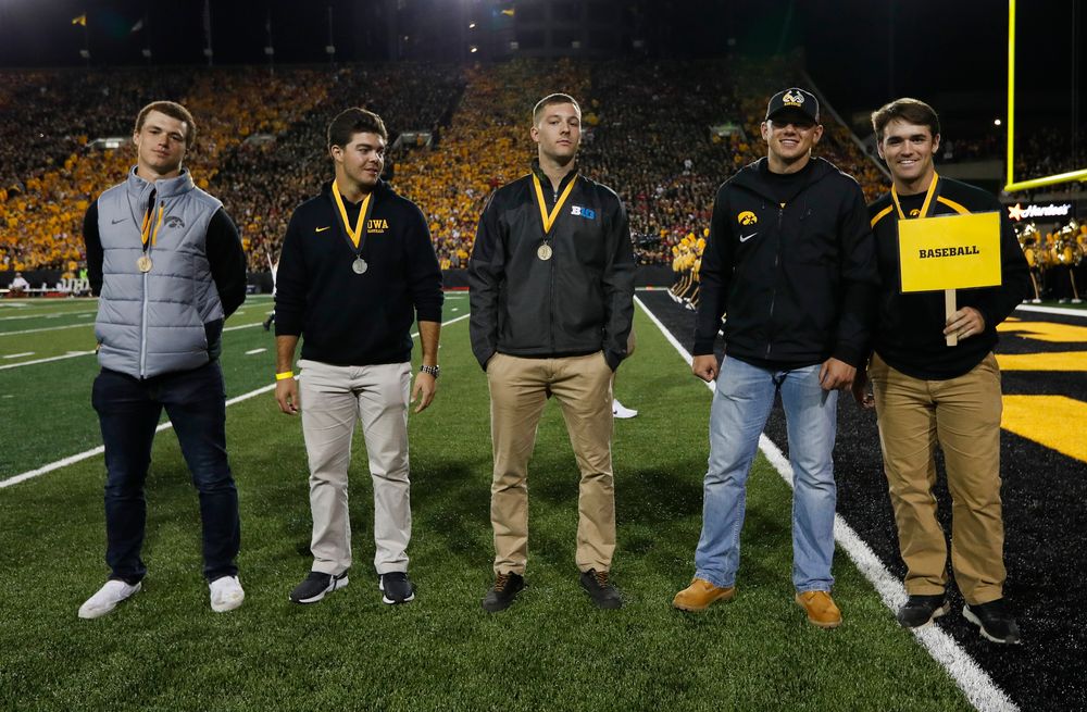 Members of the Iowa baseball team are recognized by the Presidential Committee on Athletics at halftime during a game against Wisconsin on September 22, 2018. (Tork Mason/hawkeyesports.com)