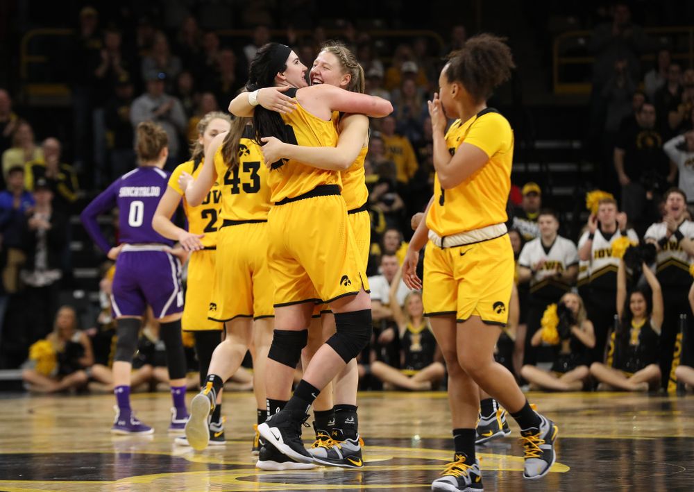 Iowa Hawkeyes forward Megan Gustafson (10) hugs center Monika Czinano (25) as she lives the court for the final time against the Northwestern Wildcats Sunday, March 3, 2019 at Carver-Hawkeye Arena. (Brian Ray/hawkeyesports.com)