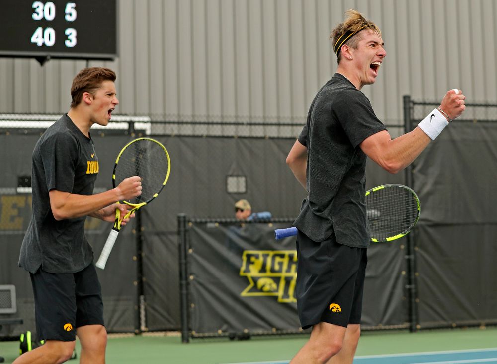 Iowa's Joe Tyler (from left) and Nikita Snezhko celebrate during a double match against Ohio State at the Hawkeye Tennis and Recreation Complex in Iowa City on Sunday, Apr. 7, 2019. (Stephen Mally/hawkeyesports.com)