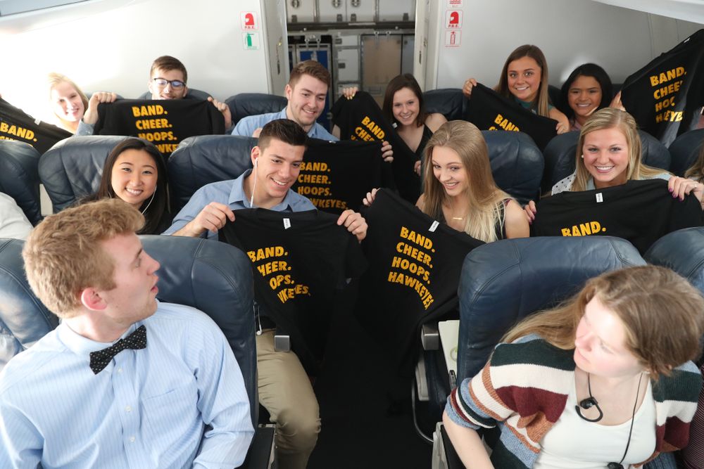 The Iowa Women's Basketball team handed out t-shirts to the band and spirit squad on board the team plane to Greensboro, NC for the Regionals of the 2019 NCAA Women's Basketball Championships Thursday, March 28, 2019 at the Eastern Iowa Airport. (Brian Ray/hawkeyesports.com)