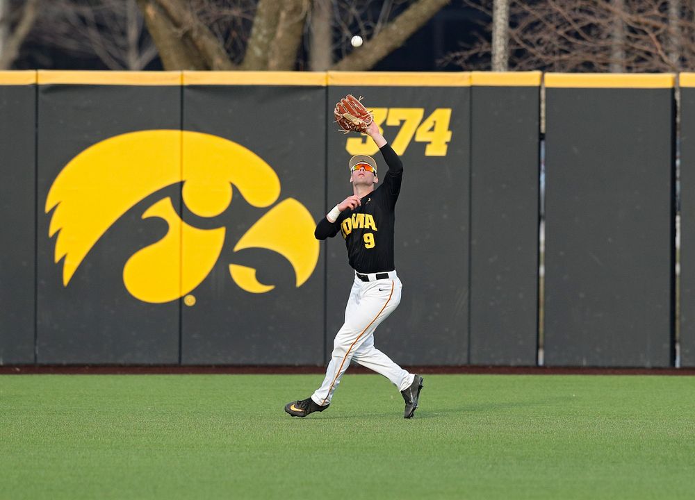 Iowa outfielder Ben Norman (9) pulls in a fly ball for an out during the seventh inning of their college baseball game at Duane Banks Field in Iowa City on Tuesday, March 10, 2020. (Stephen Mally/hawkeyesports.com)