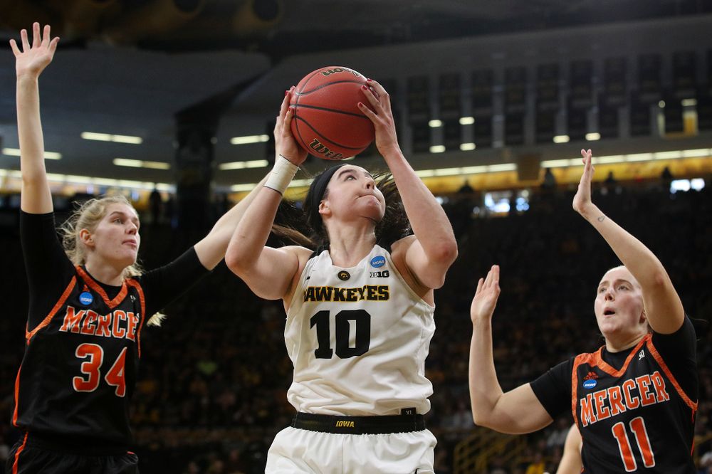 Iowa Hawkeyes forward Megan Gustafson (10) makes a basket between two defenders during the first round of the 2019 NCAA Women's Basketball Tournament at Carver Hawkeye Arena in Iowa City on Friday, Mar. 22, 2019. (Stephen Mally for hawkeyesports.com)