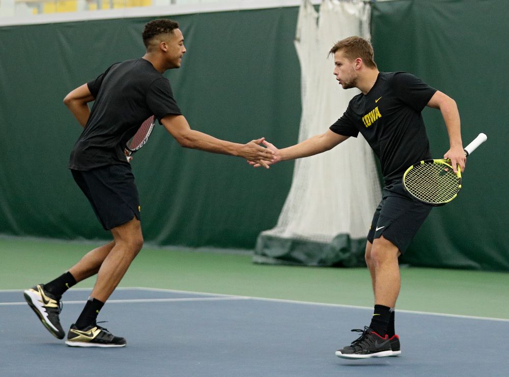 Iowa’s Oliver Okonkwo (from left) celebrates with Will Davies during their doubles match at the Hawkeye Tennis and Recreation Complex in Iowa City on Thursday, January 16, 2020. (Stephen Mally/hawkeyesports.com)
