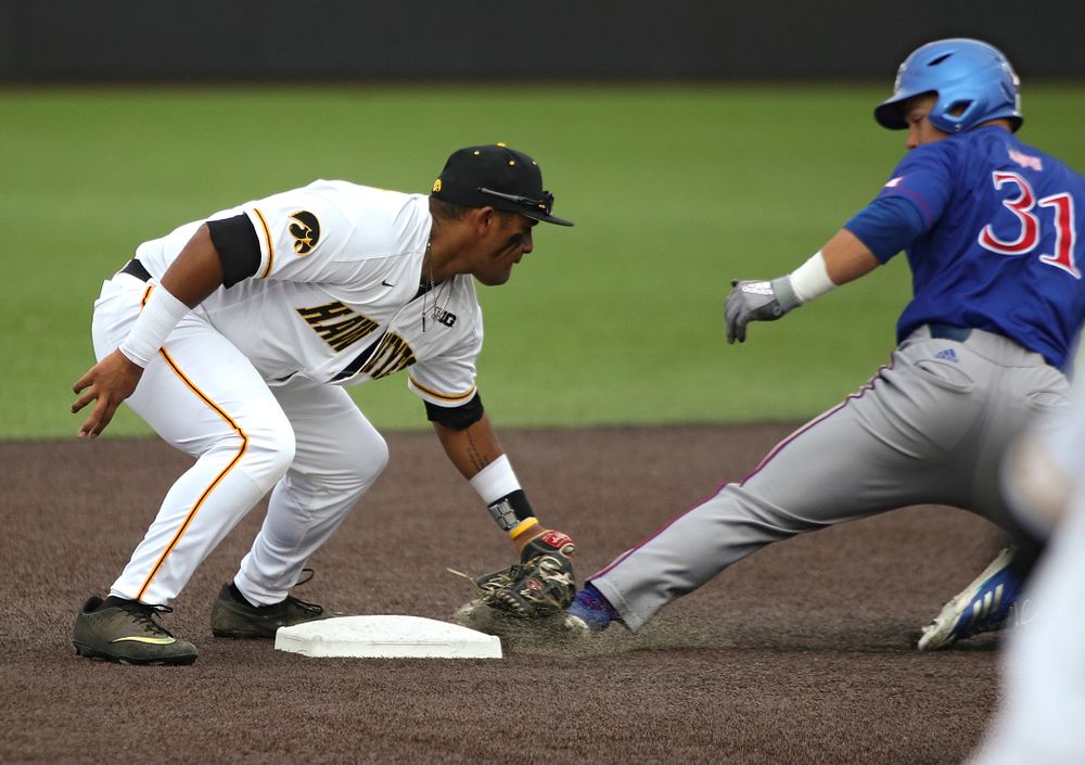 Iowa second baseman Izaya Fullard (20) tags out Kansas’ Blaine Ray as he is caught stealing during the fourth inning of their college baseball game at Duane Banks Field in Iowa City on Wednesday, March 11, 2020. (Stephen Mally/hawkeyesports.com)